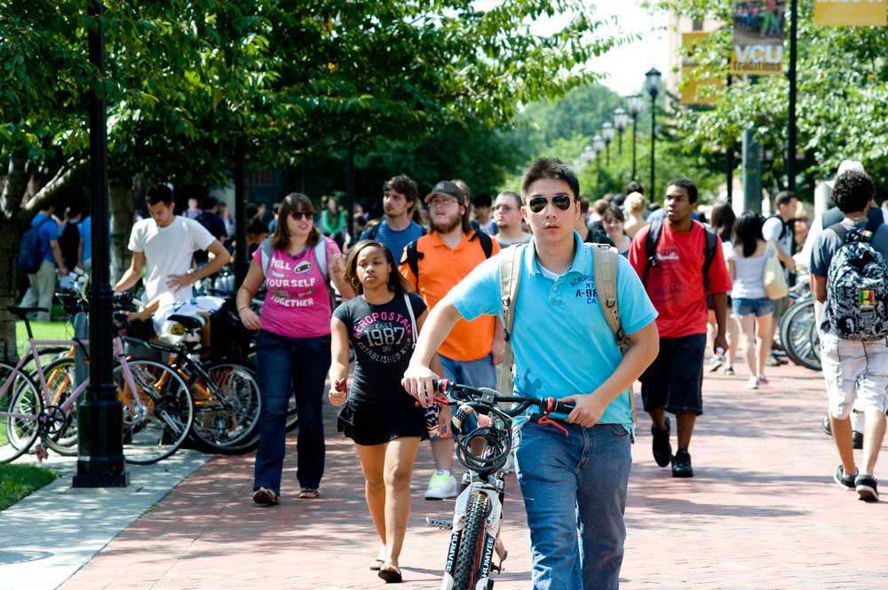 Student walking with bike