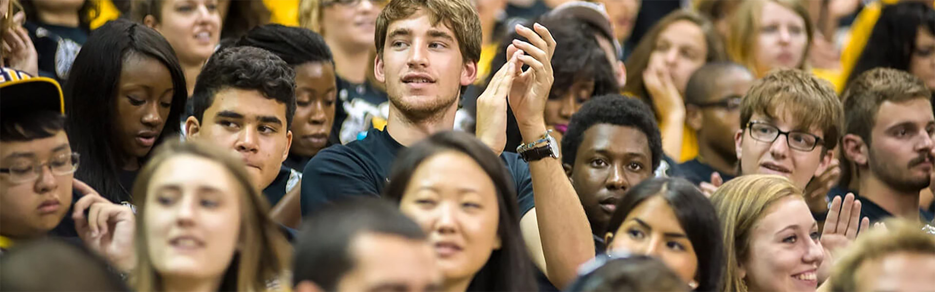 Students applauding in crowd at event